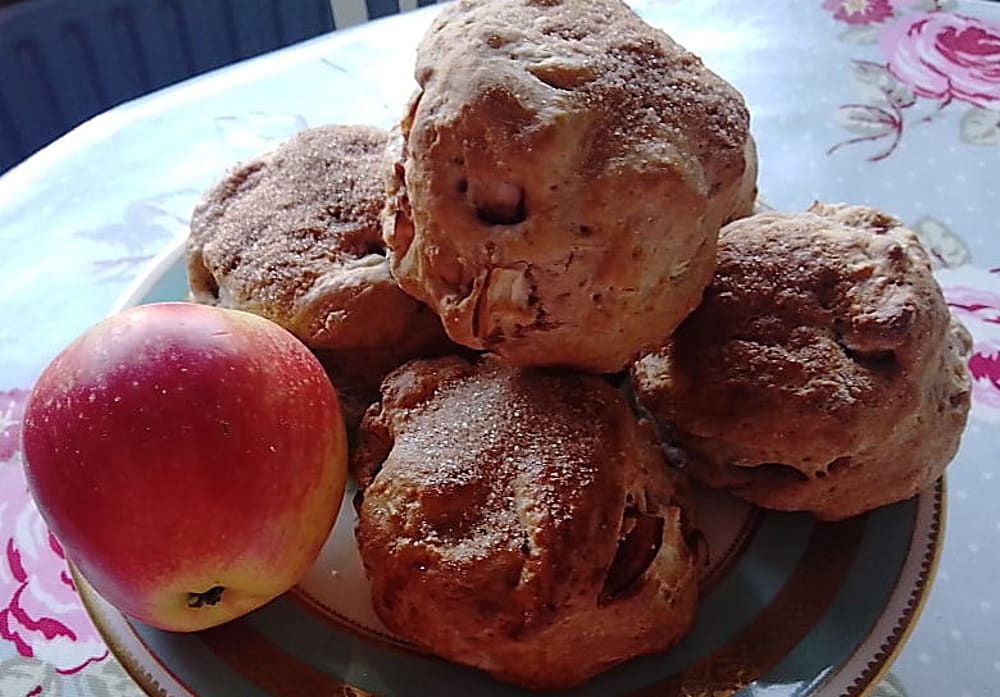 Apple and Cinnamon scones and an apple on a plate on a flowery tablecloth