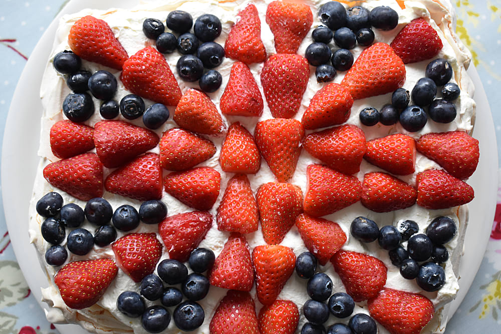 Patriotic Pavlova with strawberries and blueberries shaped to form the Union Jack flag
