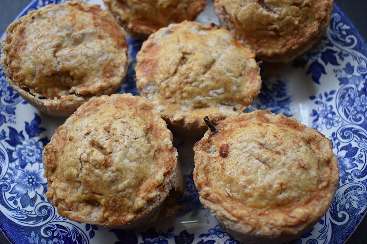 Mini Cheese and Onion Pies on a blue patterned plate