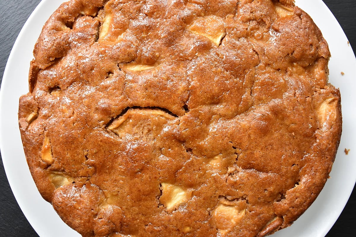 Whole Cider and Apple Cake on a white plate.