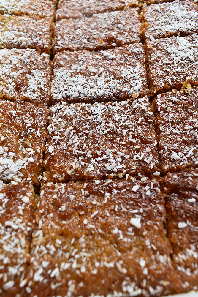 Passion Cake Traybake in traybake tin cut into slices.