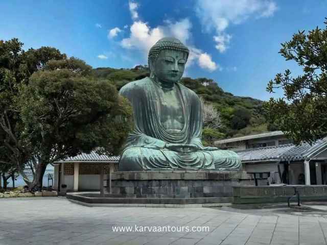 Large bronze Great Buddha statue seated outdoors at Kotoku-in Temple in Kamakura Japan