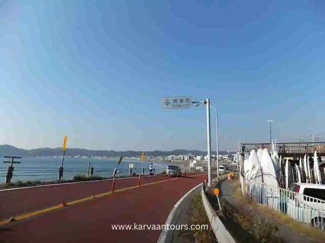 Seaside road with ocean view and vehicles along the Kamakura coastline in Japan