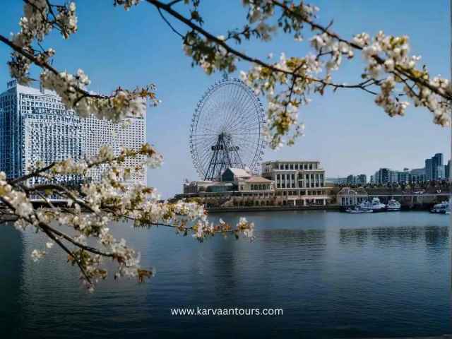 Cherry blossoms framing the Cosmo Clock 21 Ferris wheel along the Minato Mirai waterfront in Yokohama