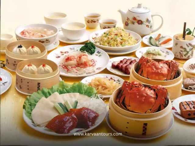 A table filled with Chinese dishes including dim sum, crab, tea, and side plates in Yokohama Chinatown