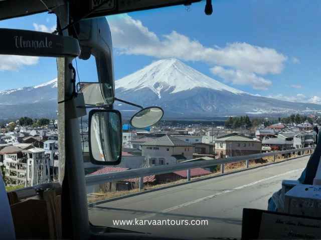 View of snow-capped Mount Fuji from a tour bus window