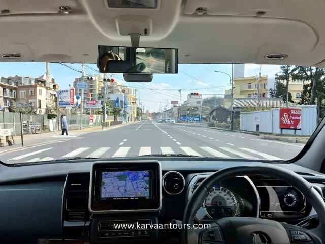 Dashboard view of a car driving on a Japanese city street