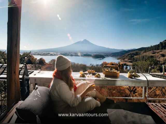Woman enjoying breakfast with a direct view of Mount Fuji
