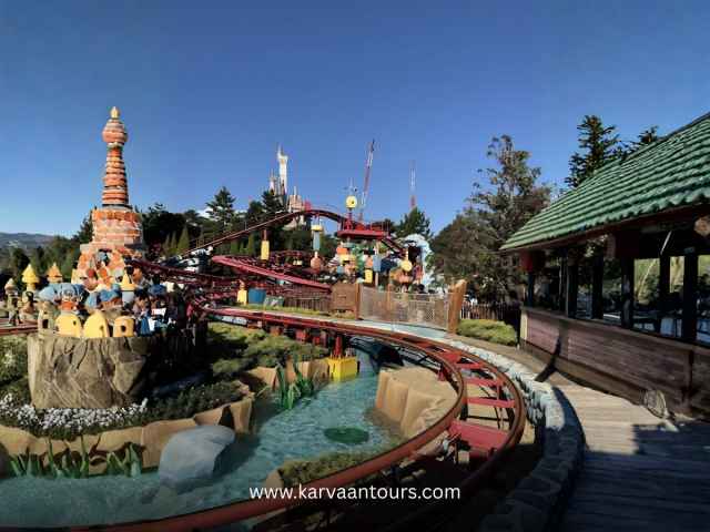 Family-friendly roller coaster winding through the colorful Toontown landscape at Tokyo Disneyland.