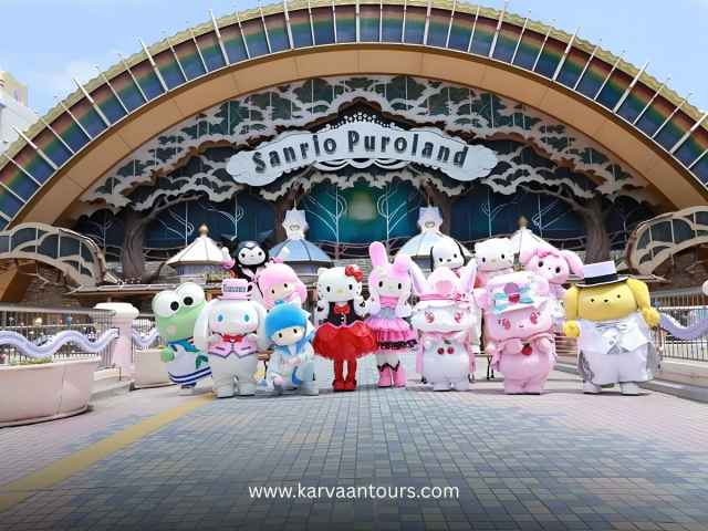 Group of Sanrio characters welcoming visitors at the colorful entrance of Sanrio Puroland indoor theme park.