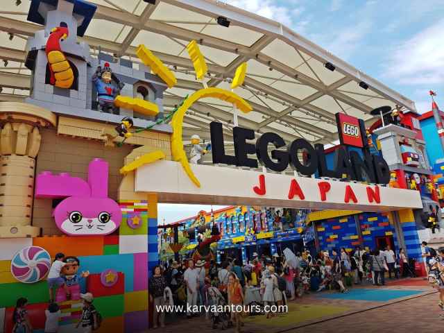 Vibrant entrance of LEGOLAND Japan in Nagoya featuring giant LEGO brick sculptures and family crowds.