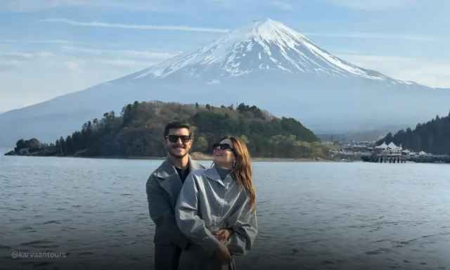 Couple posing by Lake Kawaguchi with Mount Fuji in the background, Japan