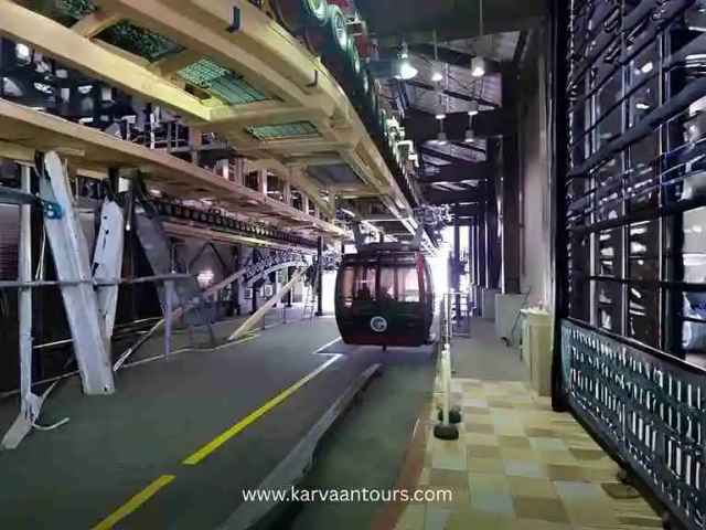 The interior boarding platform of a Hakone Ropeway station, showing the orderly row of gondolas and the mechanical structure of the cable car system.