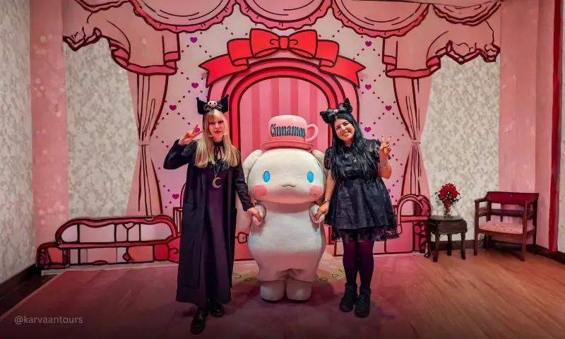 Visitors posing with Cinnamoroll mascot during meet and greet experience at Sanrio Puroland Tokyo