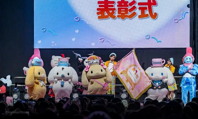 Sanrio characters on stage during awards ceremony event with audience at Sanrio Puroland Tokyo