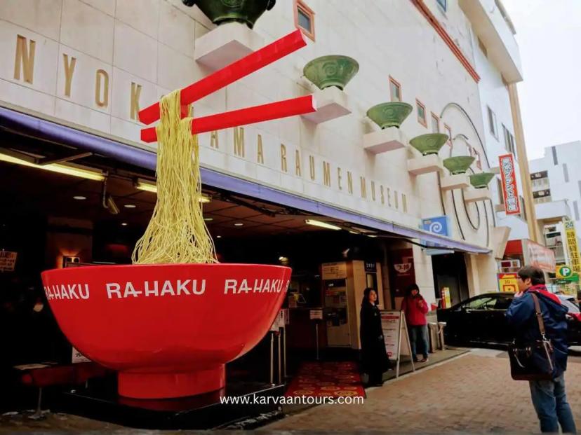 The entrance to the Shin-Yokohama Ramen Museum, featuring a large, eye-catching decorative bowl of ramen displayed outdoors to welcome visitors.