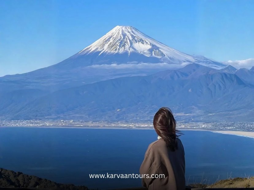 alt txt: Woman overlooking a bay with Mt Fuji in the background