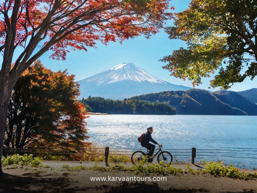 Person cycling on a path along Lake Kawaguchi in autumn