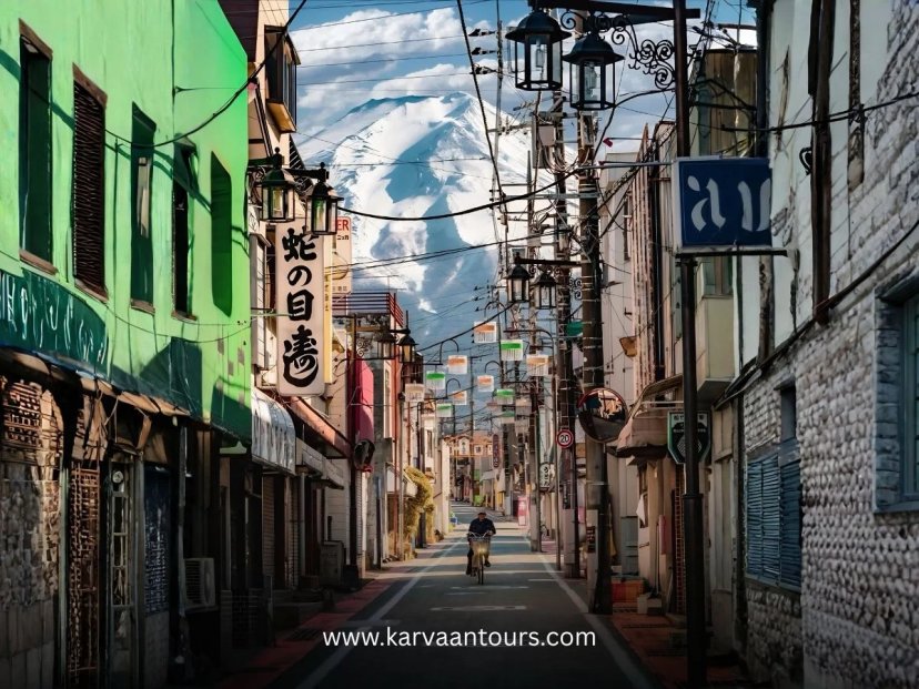 Narrow Japanese street with shops and Mount Fuji in background