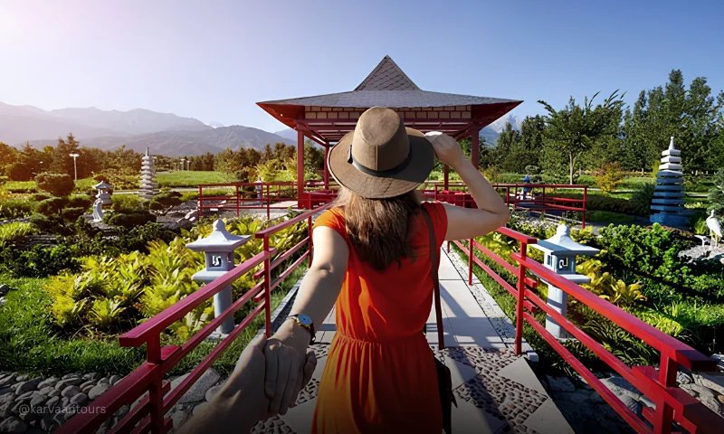 Female traveler enjoying a scenic Japanese garden and mountain landscape during a luxury cultural tour