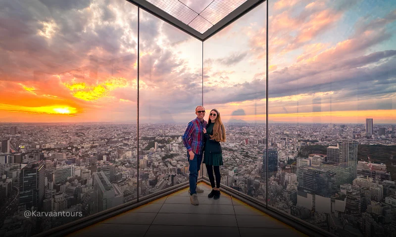 Couple posing at Tokyo City View observation deck during sunset