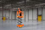 Photograph of the 020020 Dingli JCPT0507C Micro Scissor Lift PAV, in use in warehouse