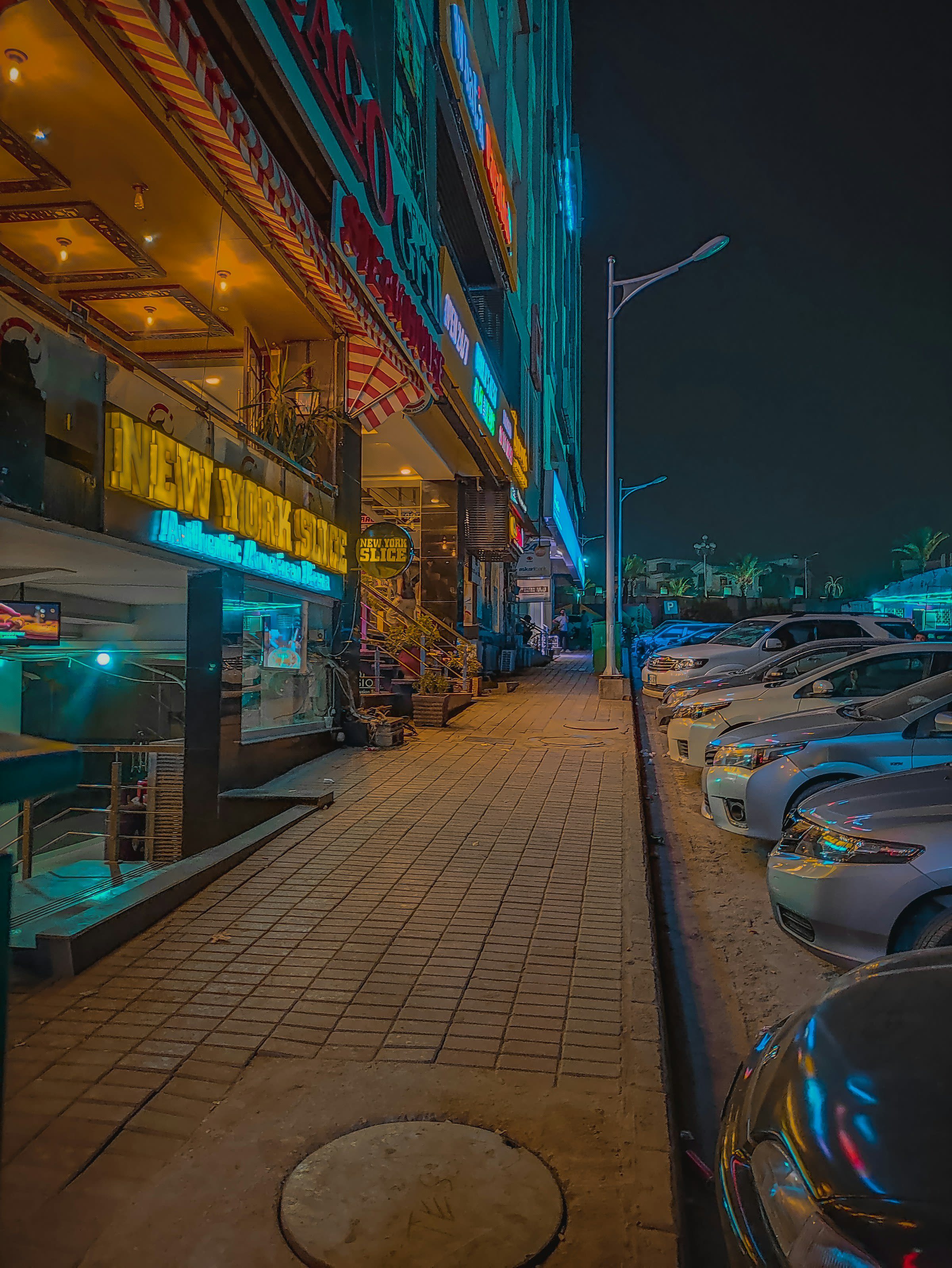 Commercial buildings and parked cars in Bahria Town Phase 4