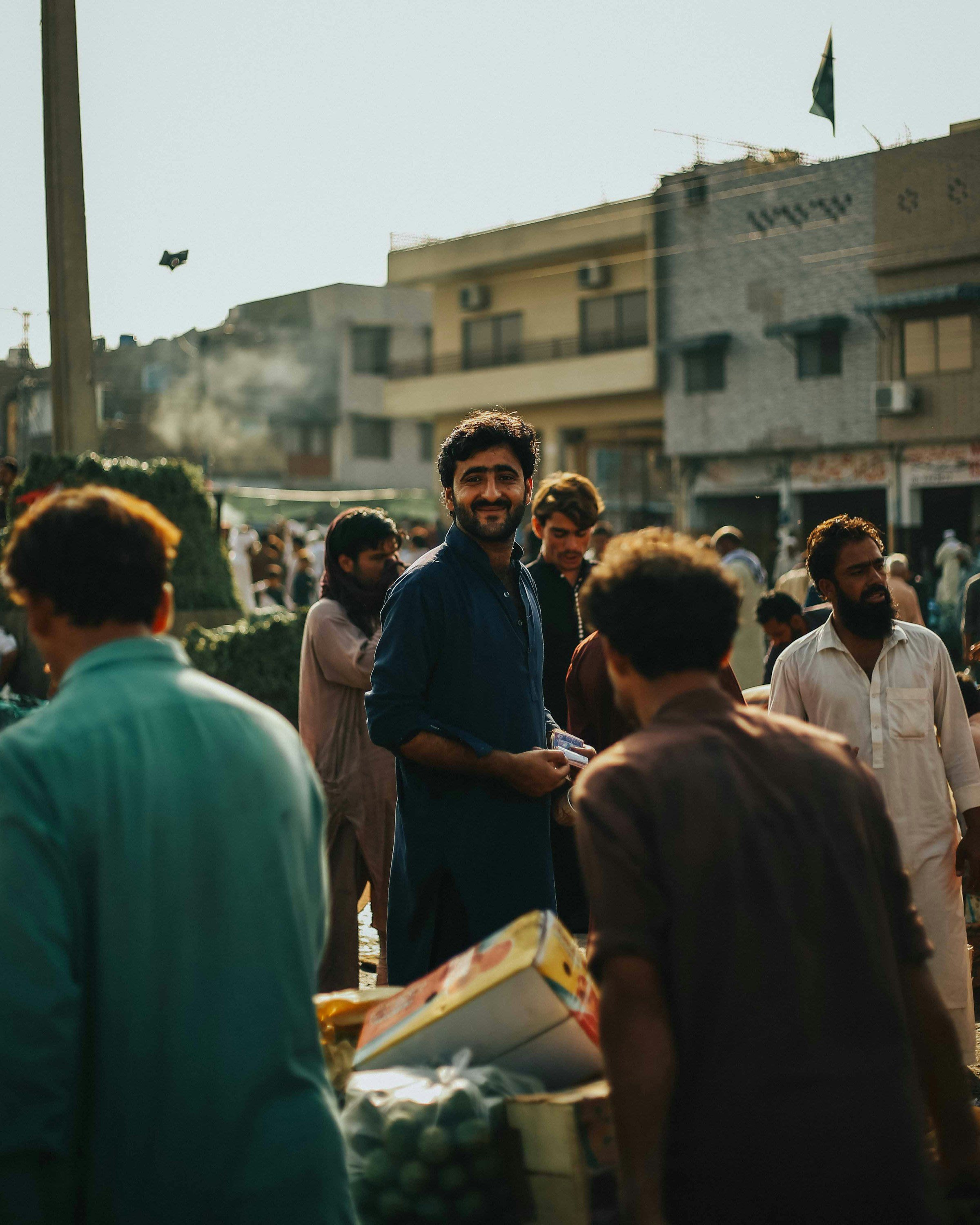 People walking through a fruit market in Islamabad