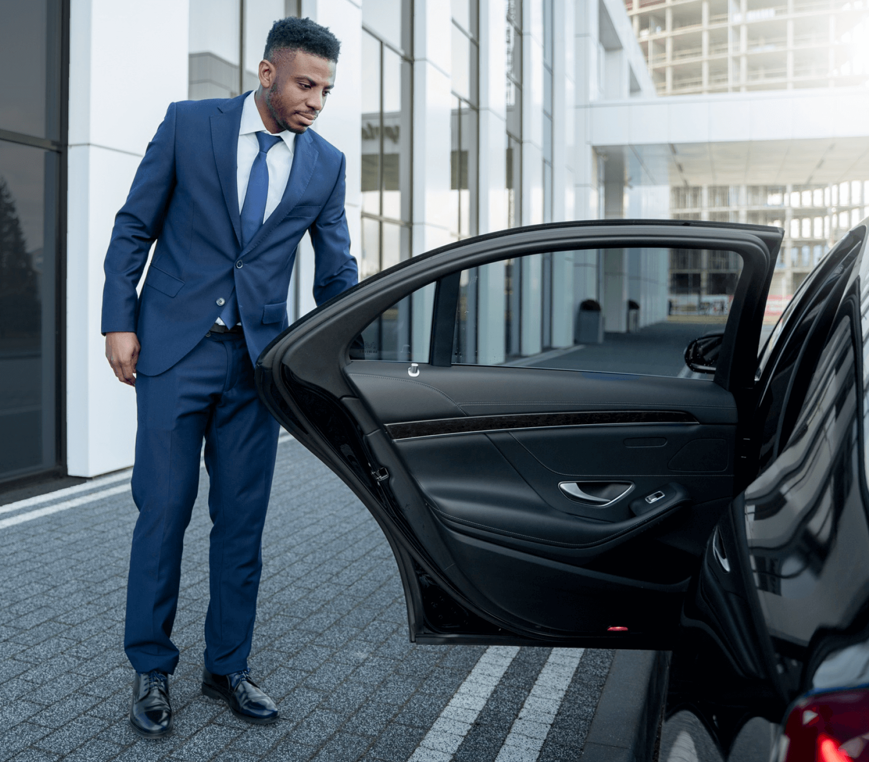 Professional driver loading luggage for a long-distance private journey