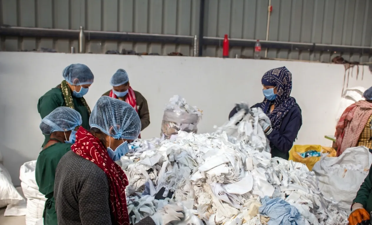 ReSutra workers handling recycled textile fiber materials