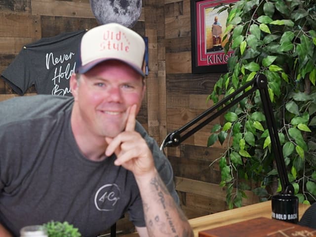 Guest leaning with old-style hat
