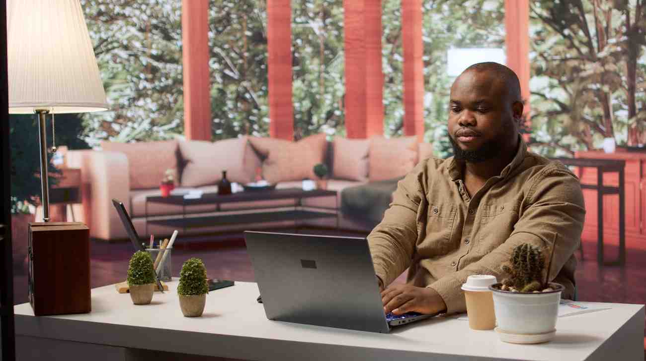 Professional working at a laptop on the Changer Fusions job board
