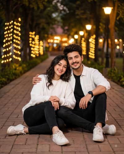 Young Couple Sitting Under String Lights at Dusk