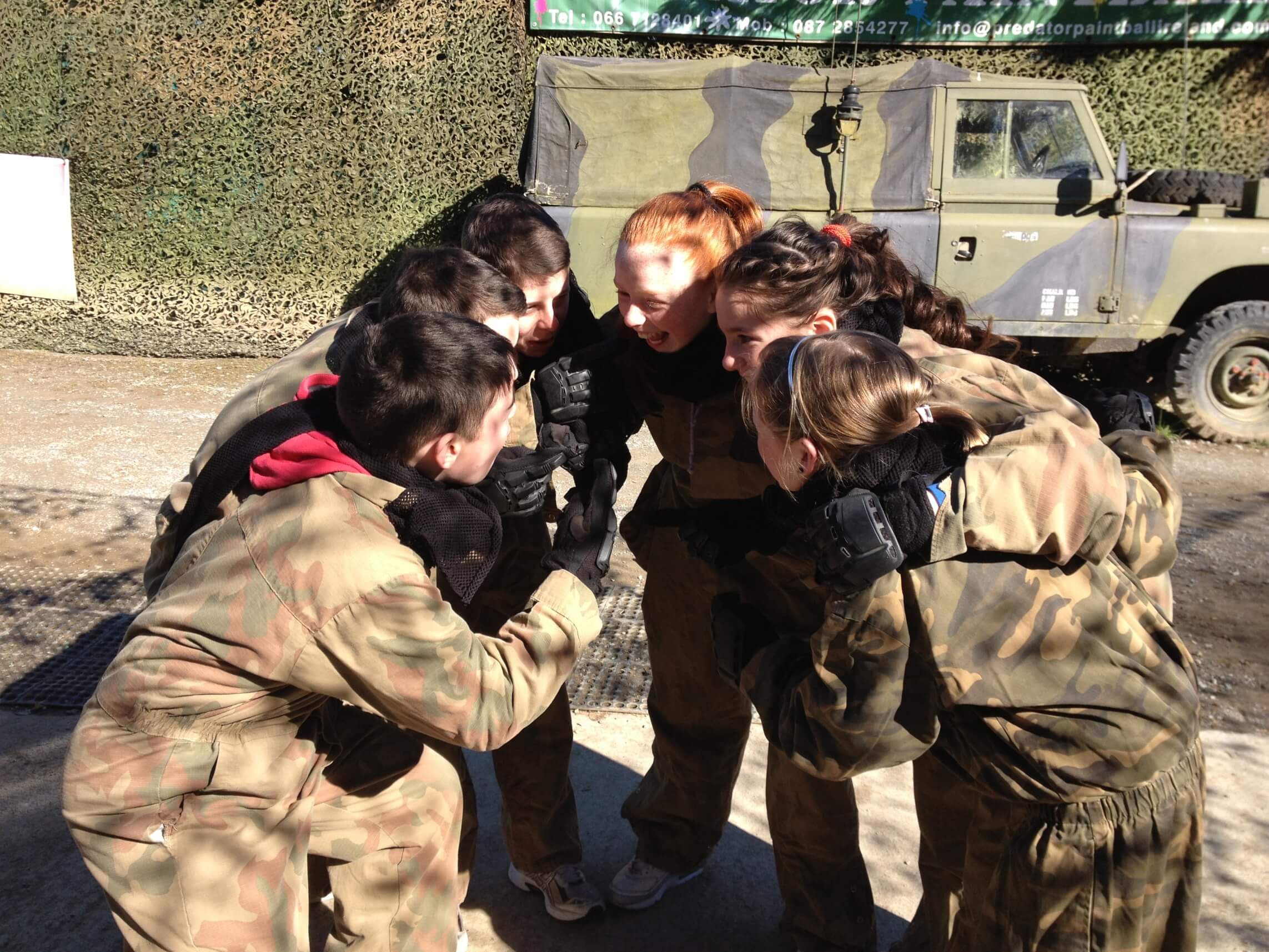 Splatball, players in a pre game huddle