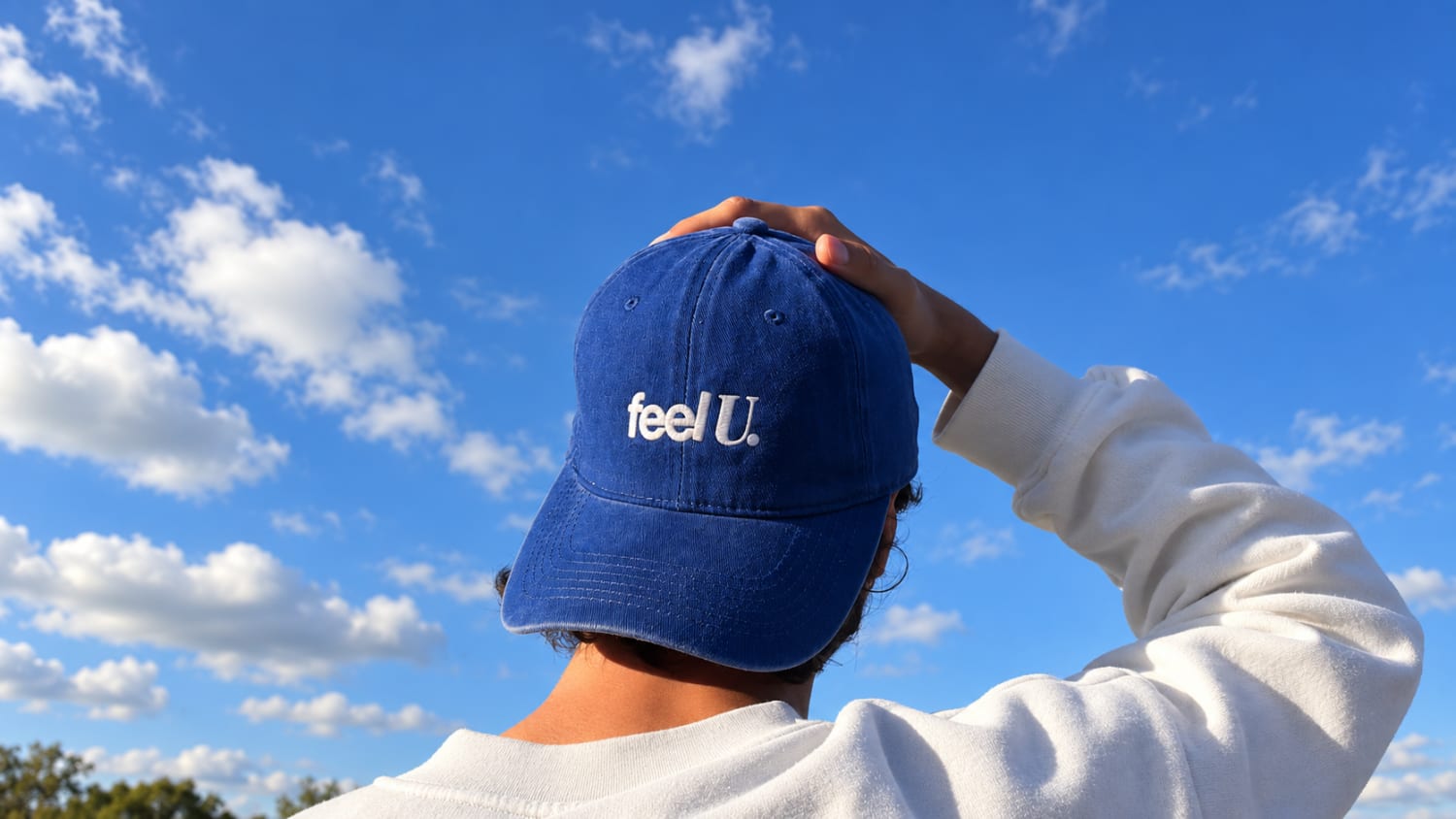 Feel U blue cap under a clear blue sky