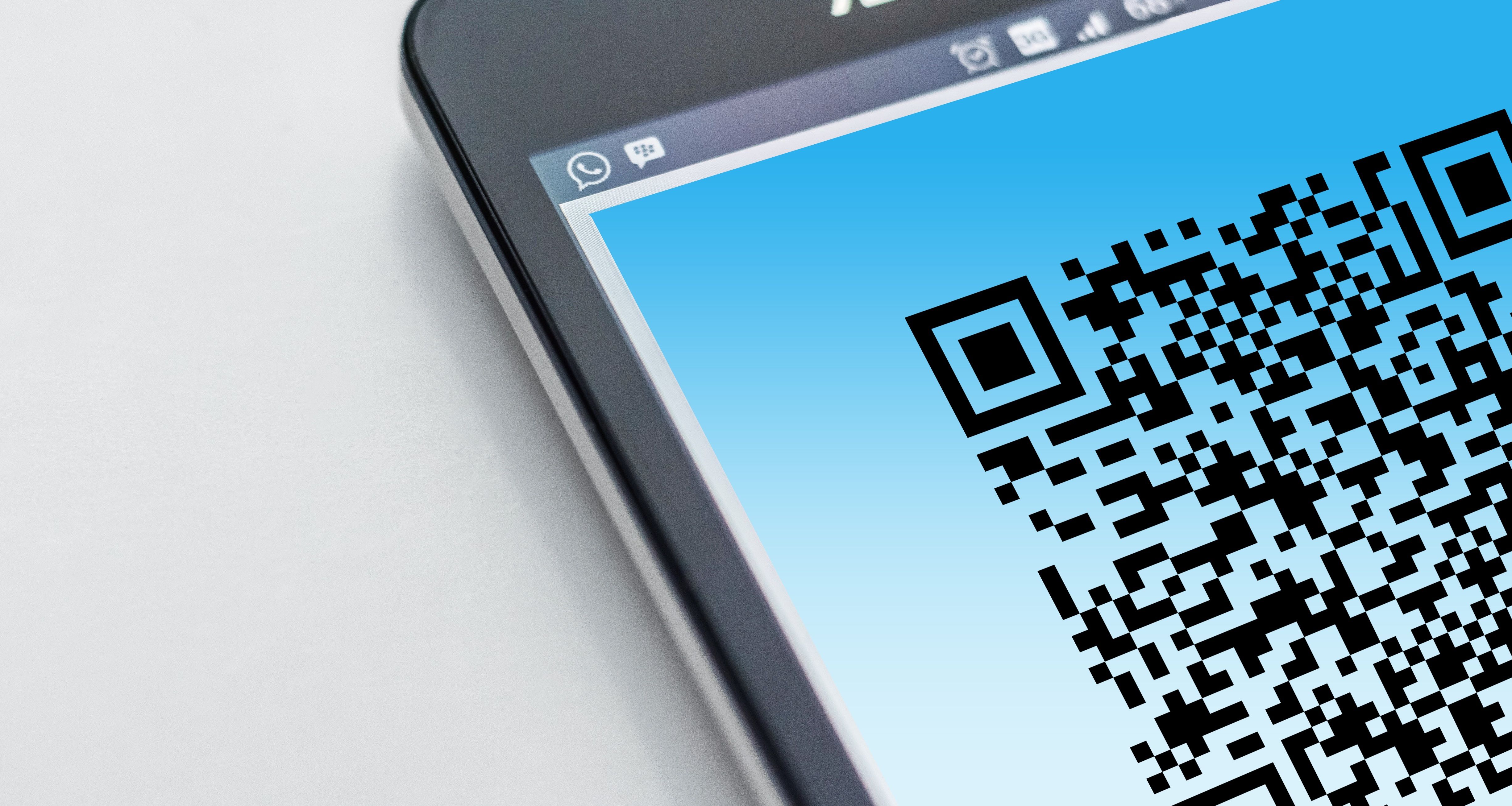 Smartphone displaying a QR code representing QR code scams and quishing attacks