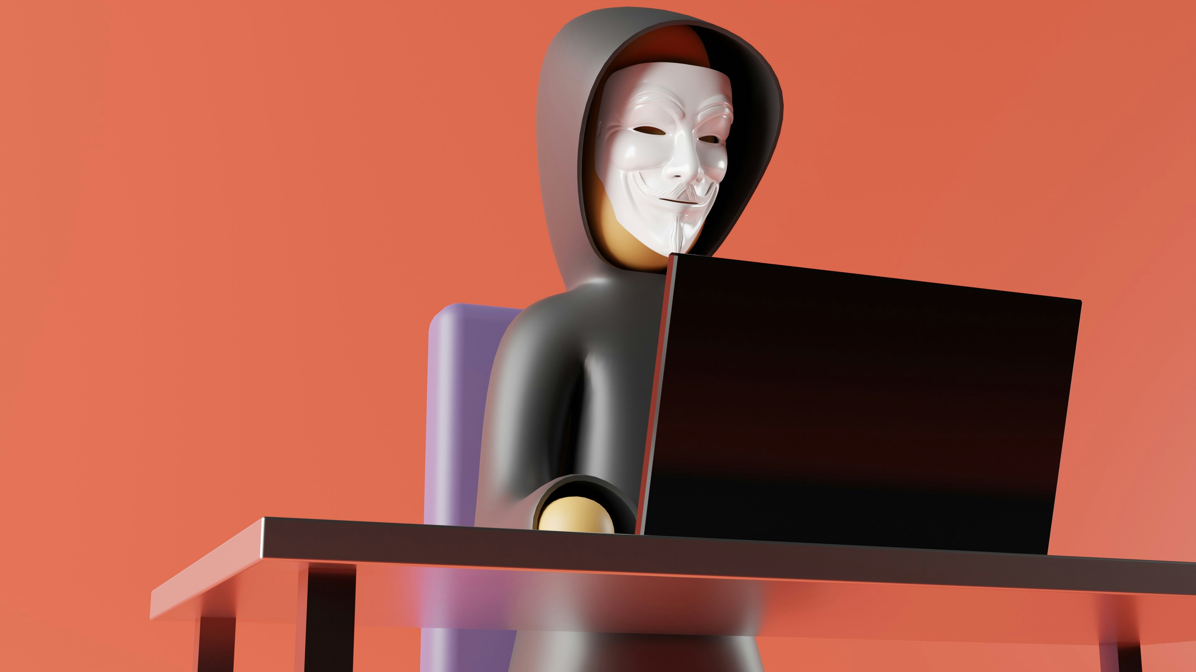 Hooded cybercriminal wearing a mask while using a laptop, representing a cyberattack targeting businesses.