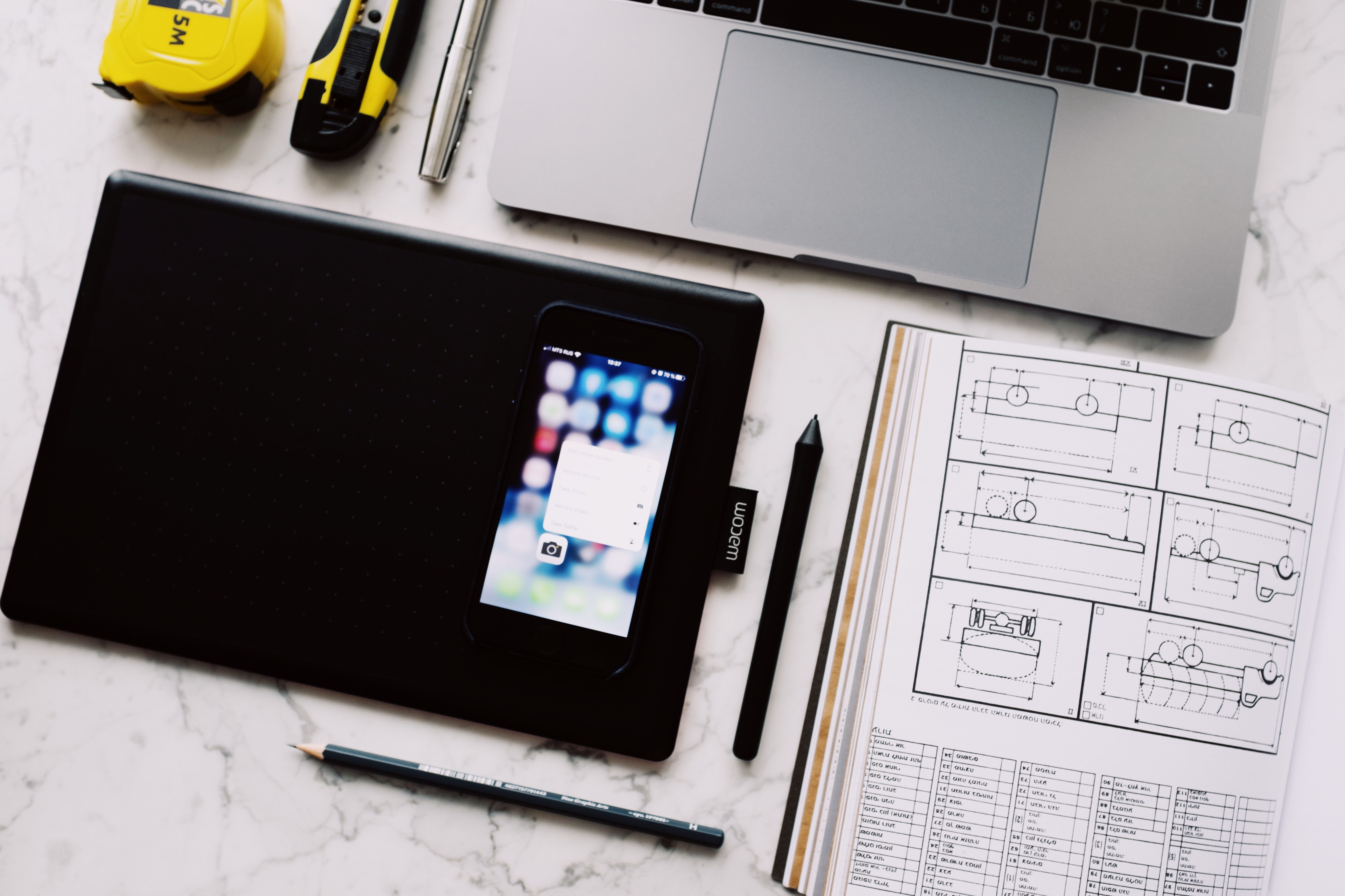 Laptop, smartphone, and digital tablet on an office desk, highlighting the importance of guest Wi-Fi security, business network protection, and IT support for small businesses in Northern Kentucky (NKY).