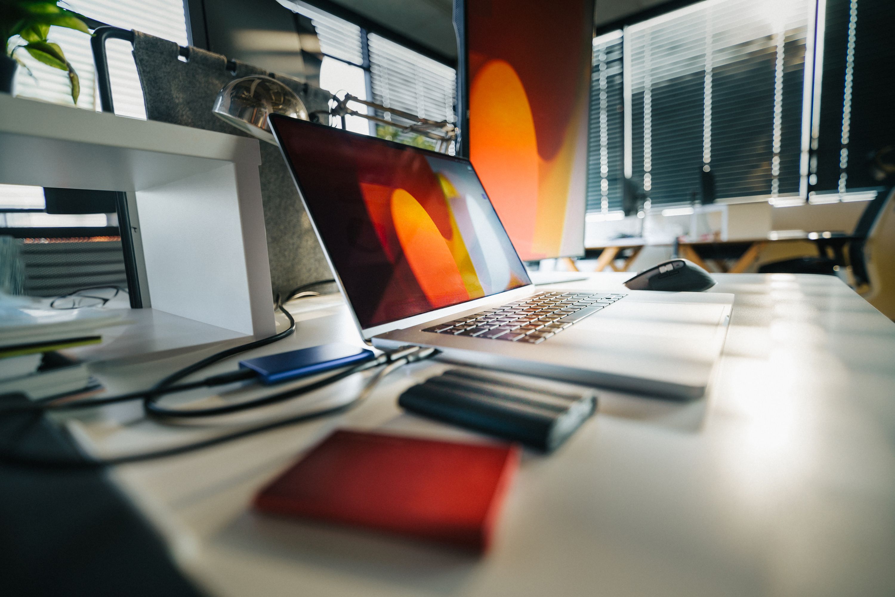 Modern office workspace with a laptop and external monitor, highlighting cloud data backup and business data protection for Northern Kentucky businesses.