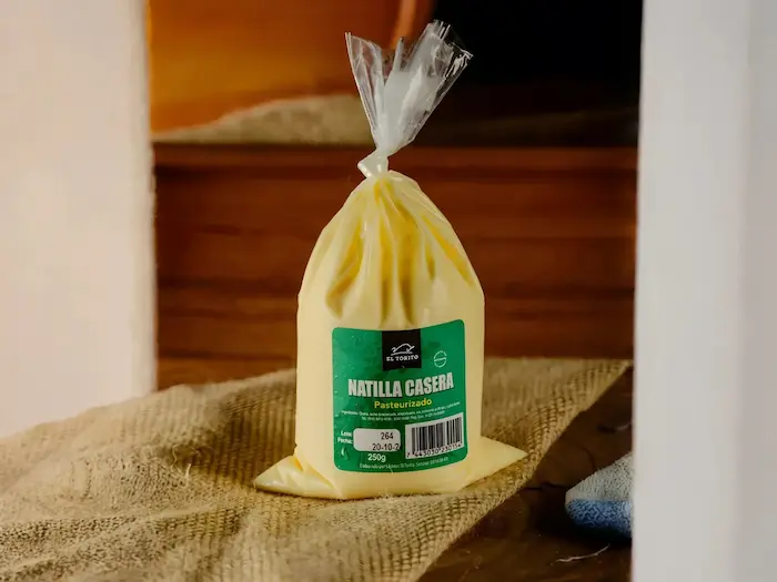 Natilla Casera encima de una mesa de madera con un fondo oscuro de madera