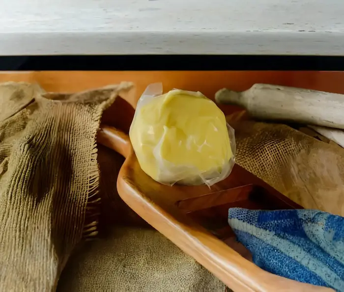 Queso Palmito en una cuchara de madera con un fondo oscuro de madera y panuelos alrededor