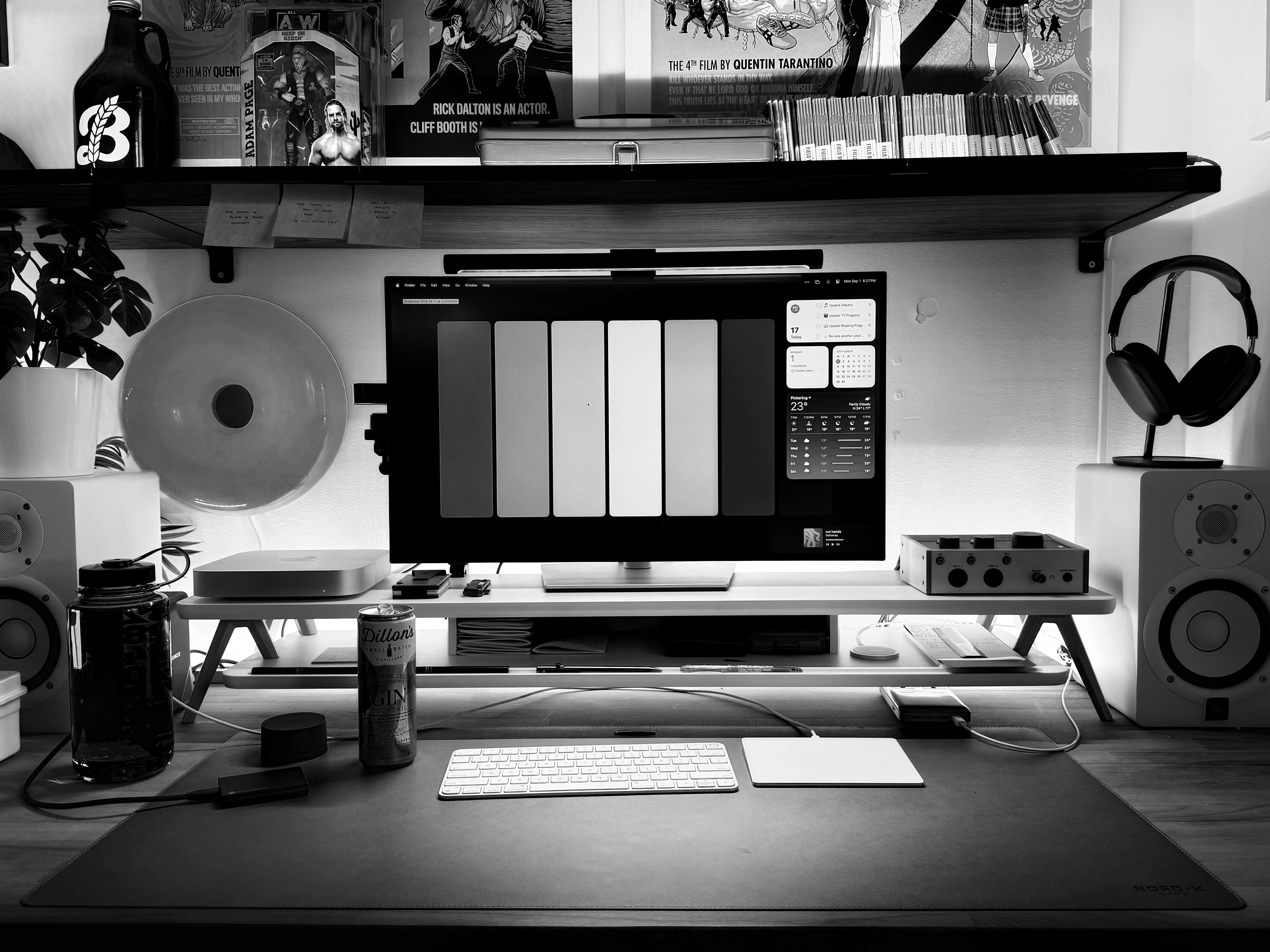 A POV of my current desk layout. There's a pair of white Yamaha monitor speakers framing a 27 inch Dell monitor and Apple Mac Mini, on a white monitor riser behind an orange desk pad.