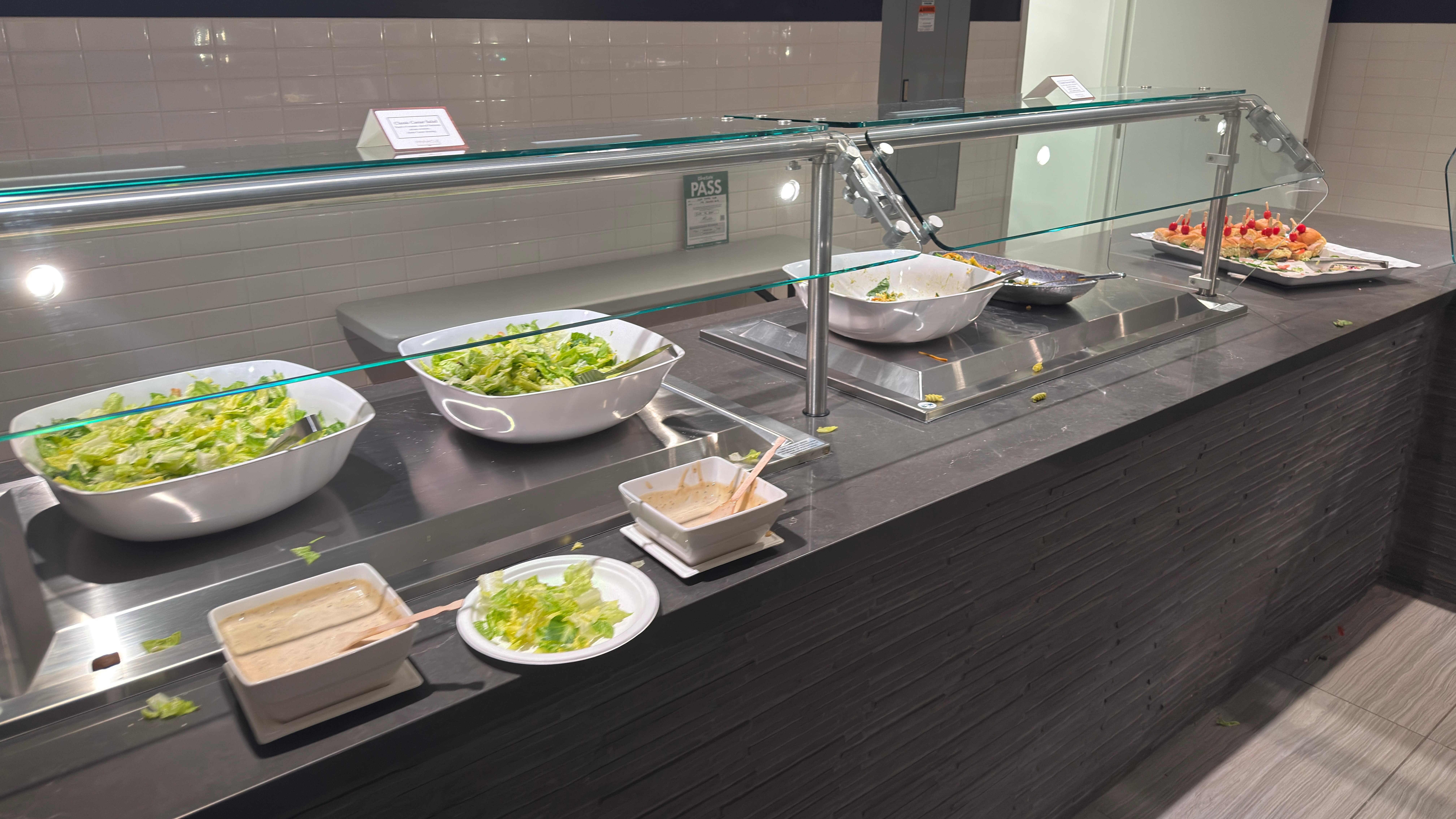 A depressing photo of a buffet station with barely any food left