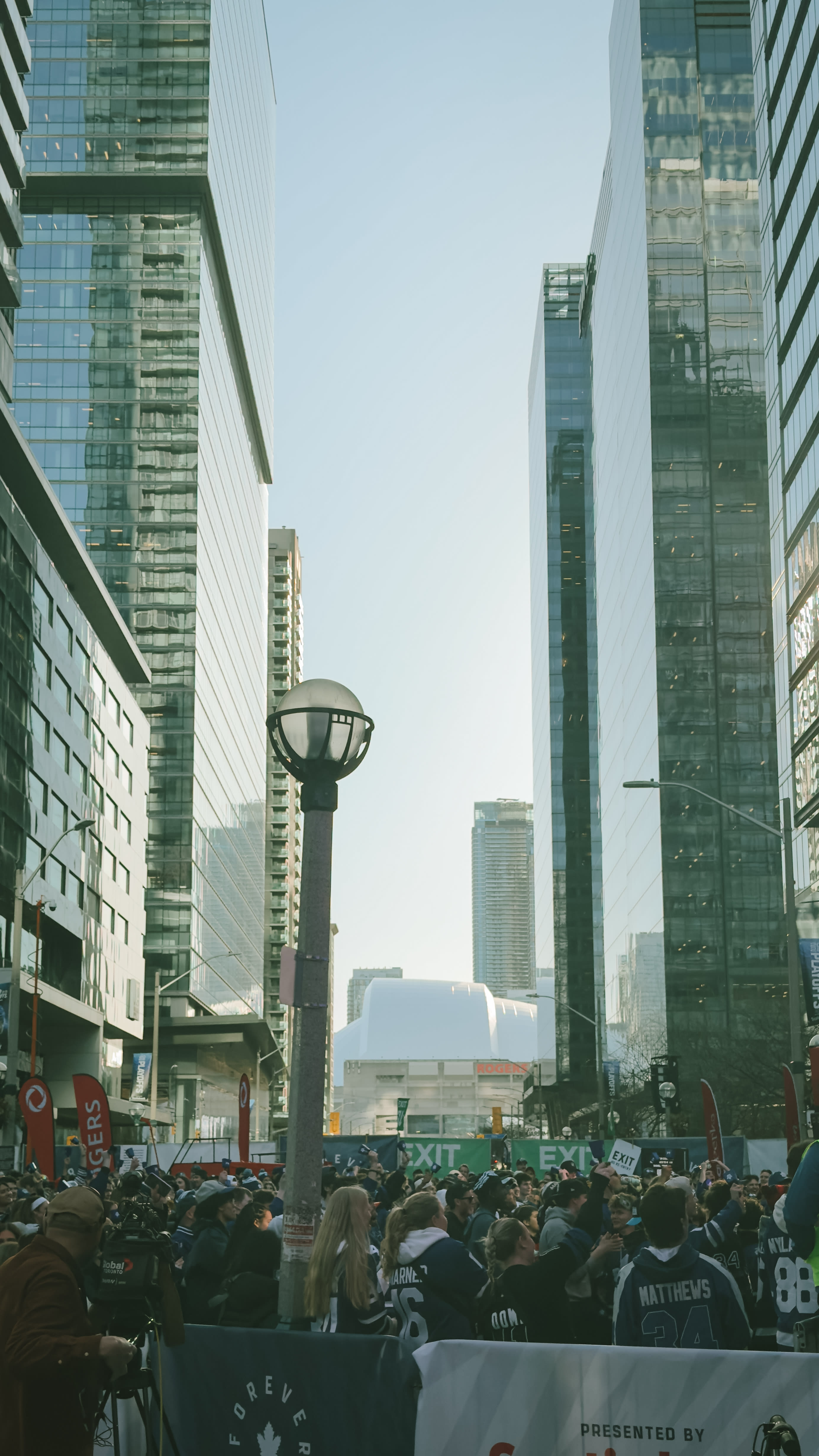 A photo I took of Leafs Square out front of Scotiabank Arena before the Leafs playoff game against the Ottawa Senators on April 22, 2025. The square is packed with fans in blue & white jerseys.