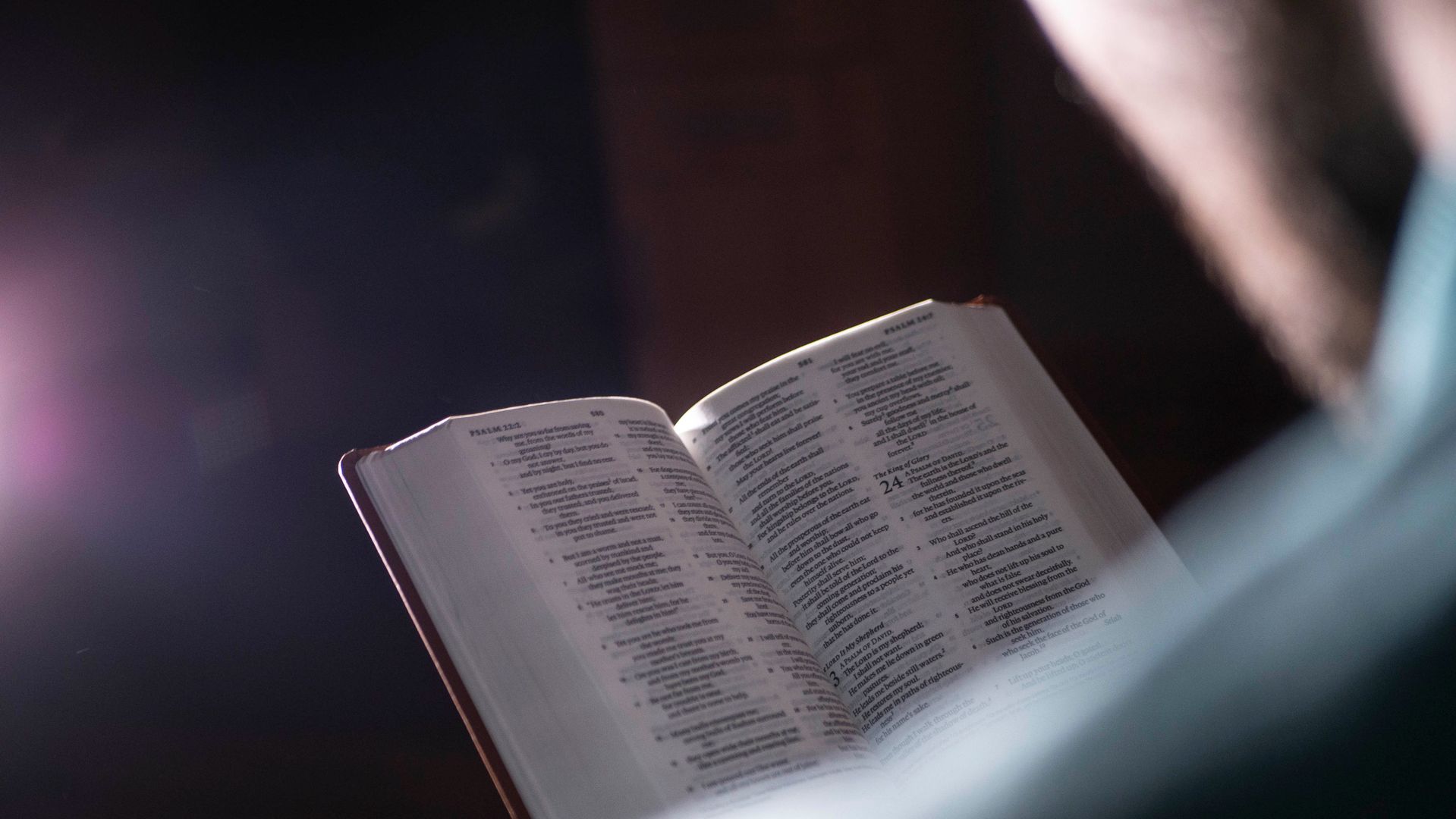 An open book with scripture pages visible in soft lighting, creating a serene atmosphere. Source: pexels.com (K2 Production)