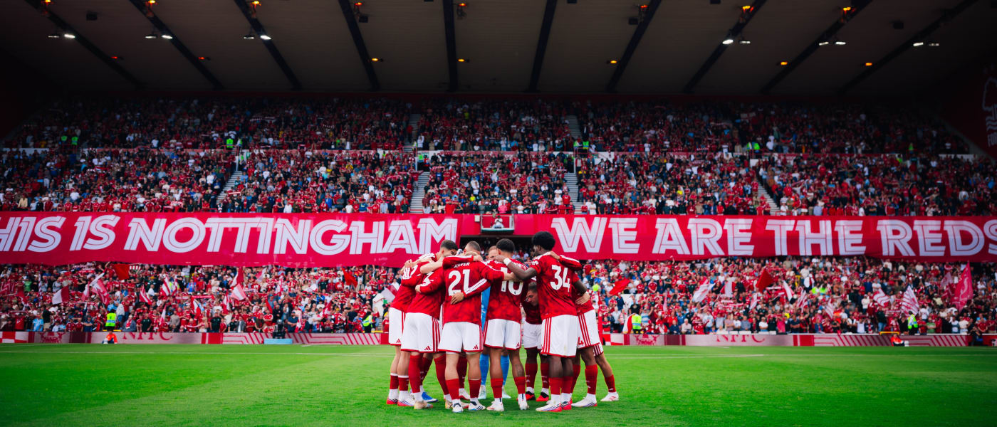 Nottingham Forest players huddle in front of the Trent End at the City Ground