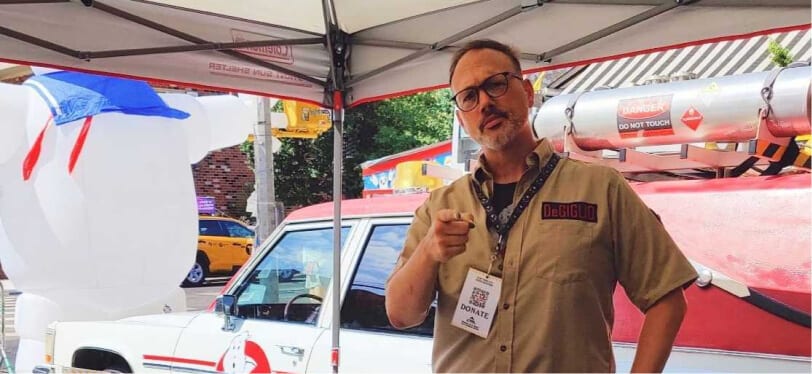NYC Ghostbuster member Peter DeGiglio pointing at camera in front of ECTO NYC and Slime Lab.