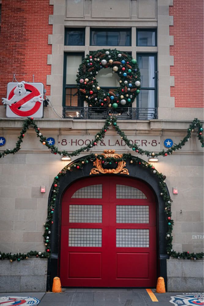 Ghostbusters firehouse. a red door with a wreath on top of it. Christmas. Photo by Dmitry Kropachev on Unsplash.