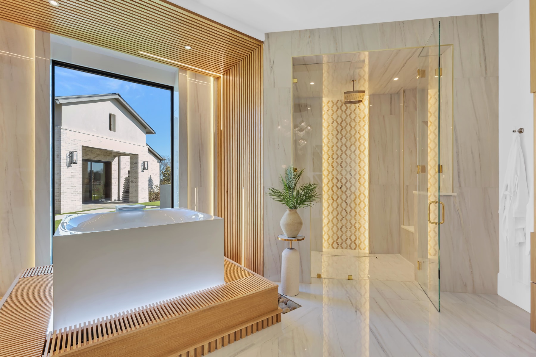 Spa bathroom with soaking tub and gold mosaic steam shower in an Allen, Texas estate