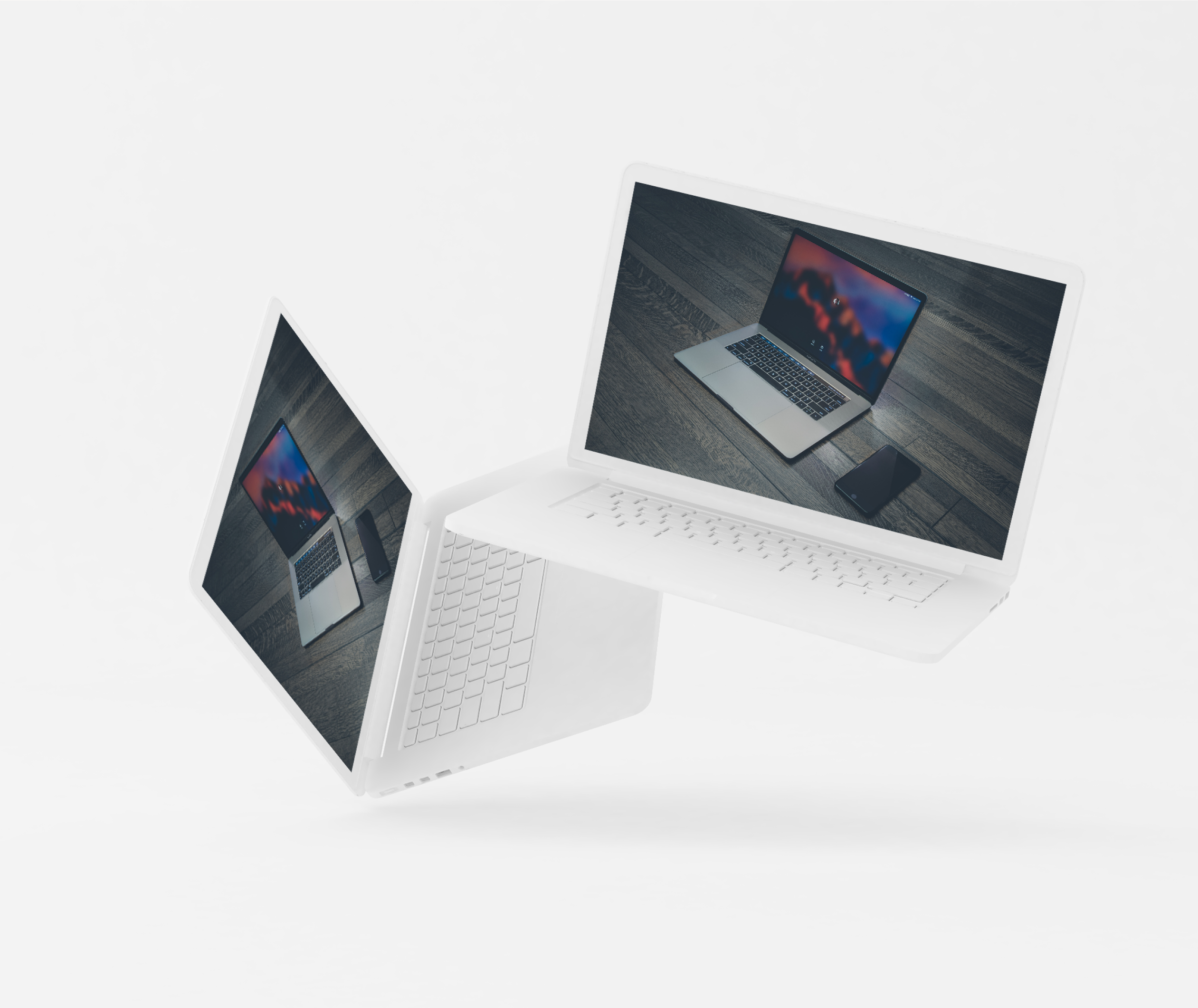 Two laptops floating in the air with one showing a blurred screen and the other showing a keyboard